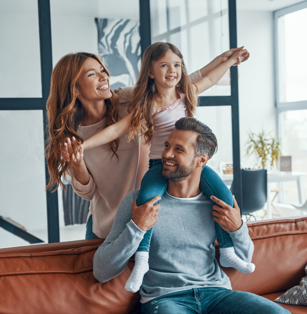 Happy young family smiling and embracing while bonding together